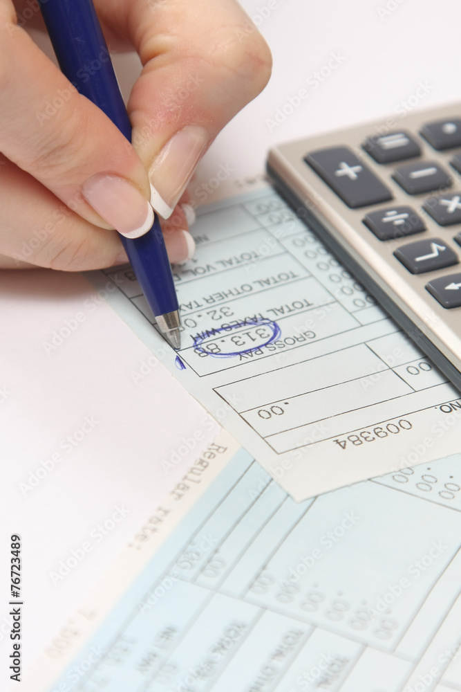 Financial data analyzing. Counting on calculator. A hand with a Financial data analyzing. Counting on calculator. A hand with a