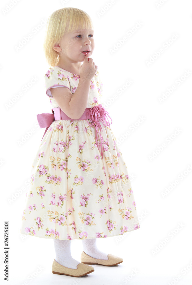 Thoughtful little girl in a long dress. Thoughtful little girl in a long dress.