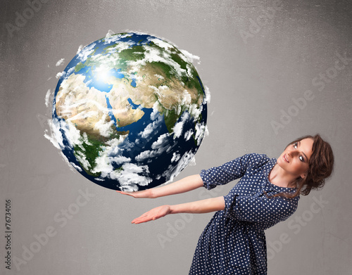 Pretty girl holding 3d planet earth photo