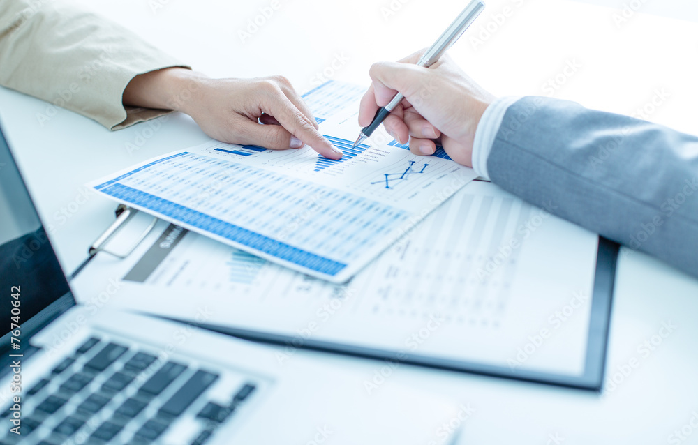 Business people discussing the charts and graphs showing the res Business people discussing the charts and graphs showing the res