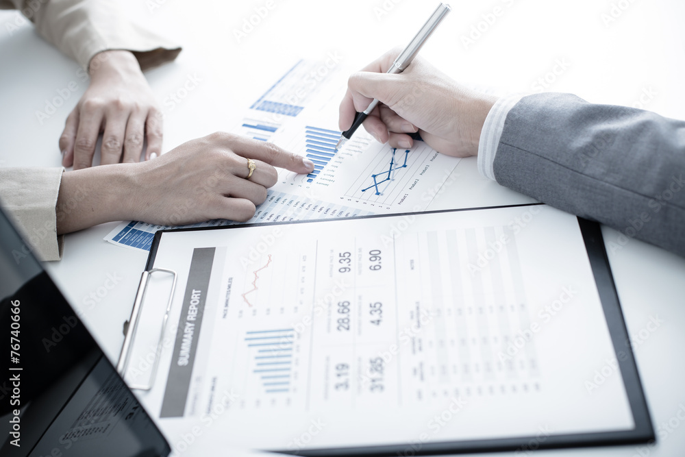 Business people discussing the charts and graphs showing the res Business people discussing the charts and graphs showing the res