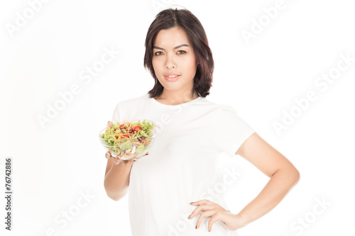 Pretty girl eating fresh vegetable salad