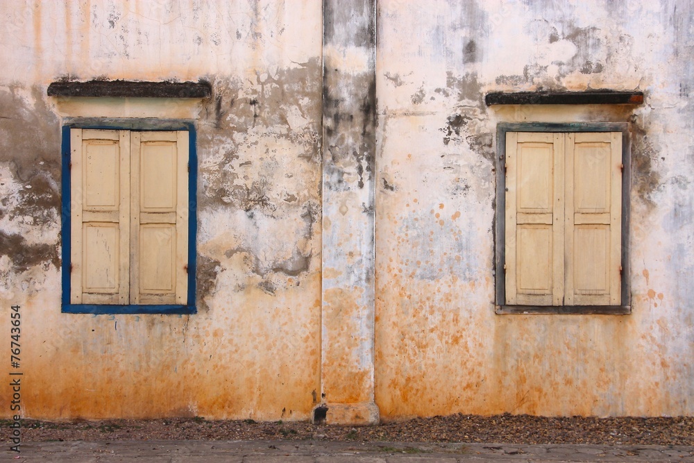 Two antique window frames on an old wall