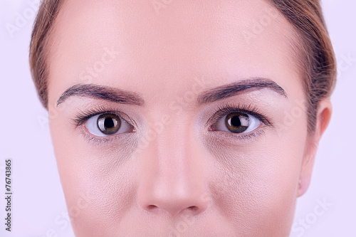 Applying makeup on female f...