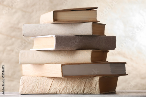 Stack of books on textured background