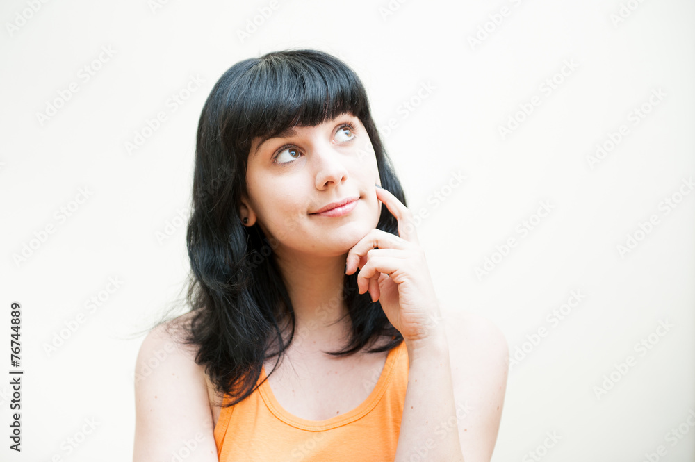 Girl standing looking up thinking and dreaming on white backgrou Girl standing looking up thinking and dreaming on white backgrou
