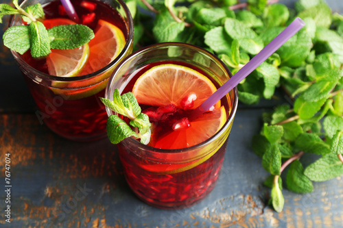 Pomegranate drink in glasses with slices of lime and mint