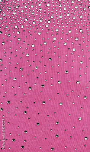 pink fabric is decorated with jewelry