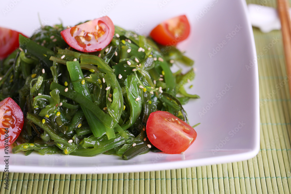 Seaweed salad with slices of cherry tomato