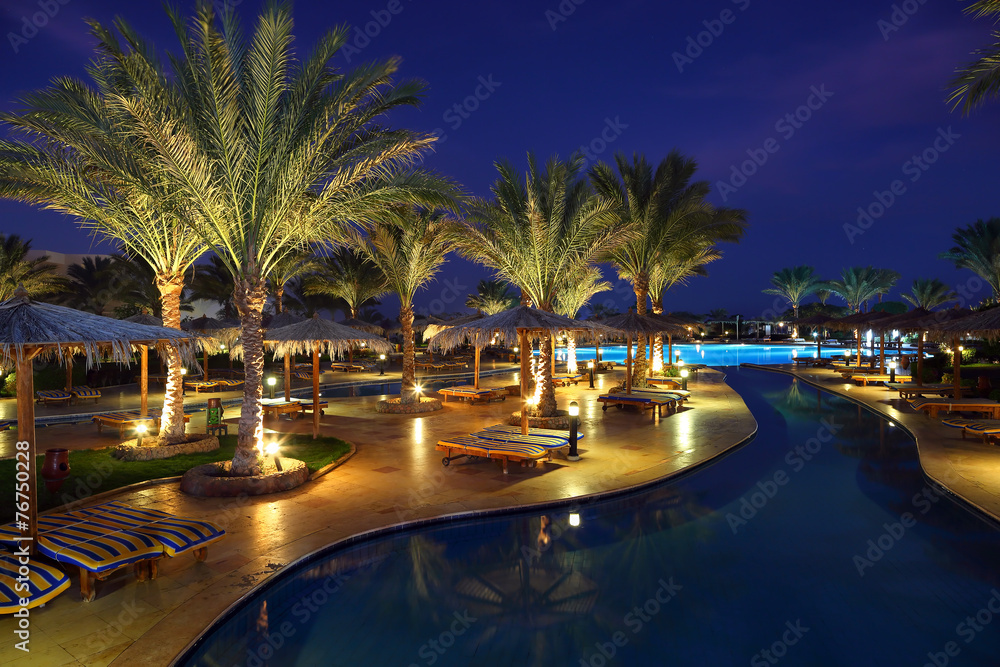 LuxuryTropical Resort Pool in dusk - obrazy, fototapety, plakaty 