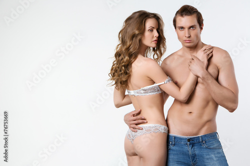 Beautiful sexy couple in love on white background.