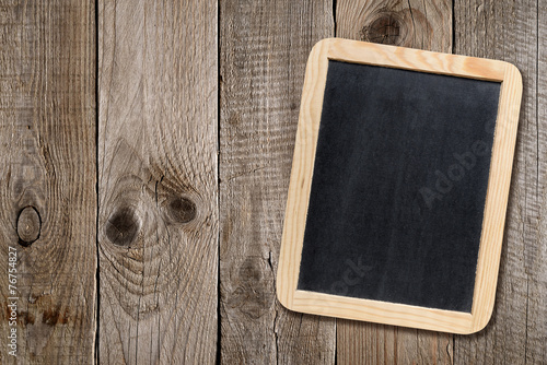 Small blackboard on wooden background