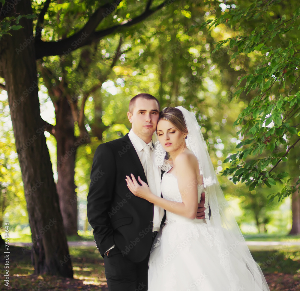 Elegant bride and groom posing together outdoors on a wedding da