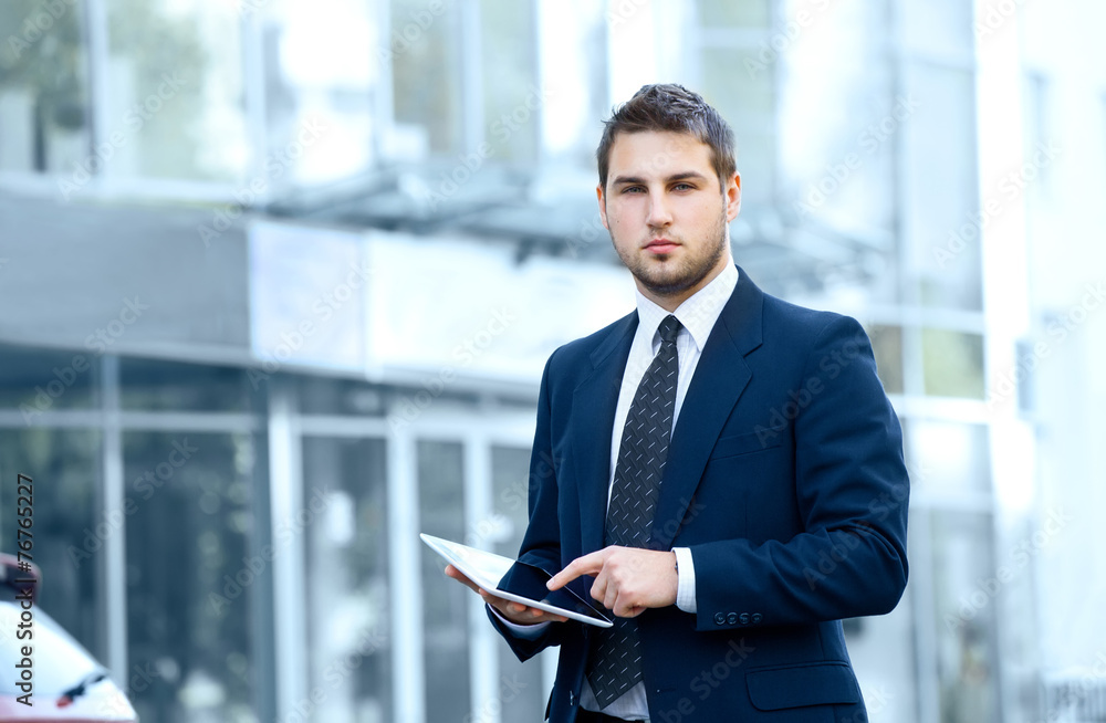 Businessman using a digital tablet computer Businessman using a digital tablet computer