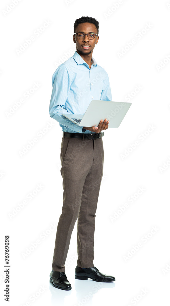 Happy african american college student standing with laptop on w Happy african american college student standing with laptop on w