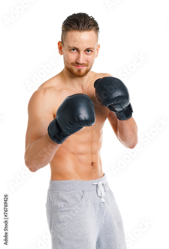 Athletic attractive man wearing boxing gloves on the white