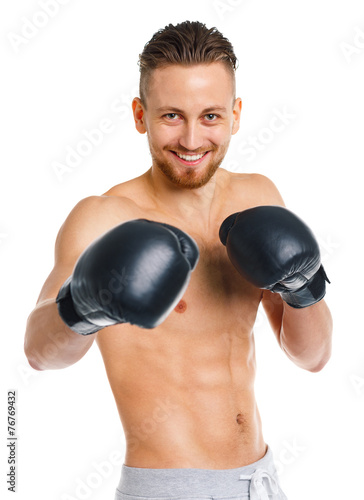 Athletic attractive man wearing boxing gloves on the white