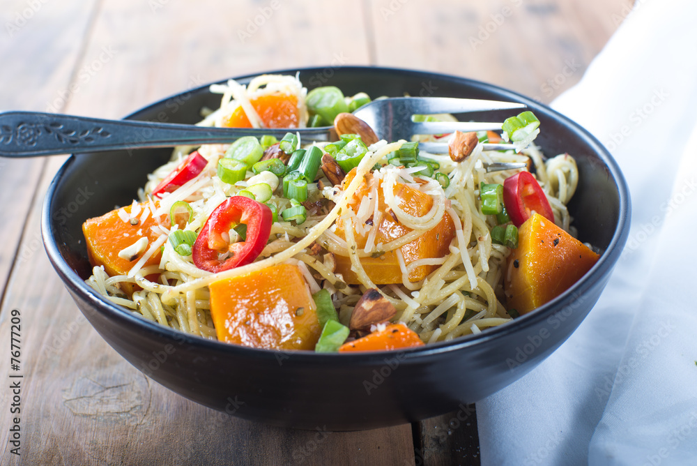 Bowl of pesto pasta with fresh vegetables Bowl of pesto pasta with fresh vegetables