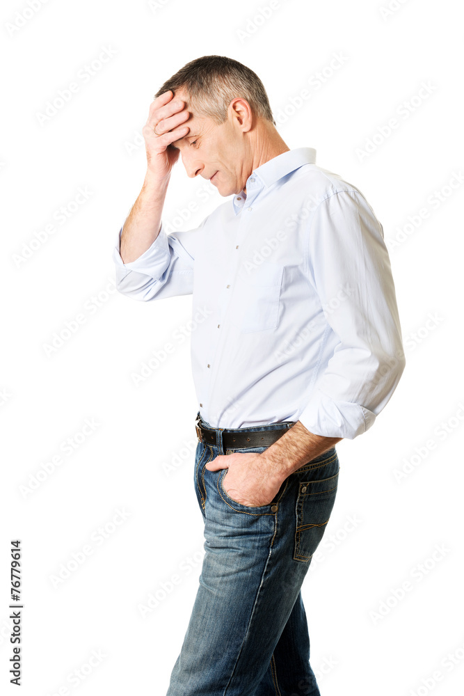 Depressed man touching his head Depressed man touching his head