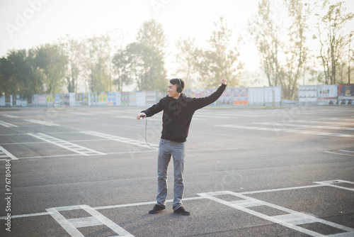 young crazy funny asian man in town outdoor lifestyle listening © Eugenio Marongiu