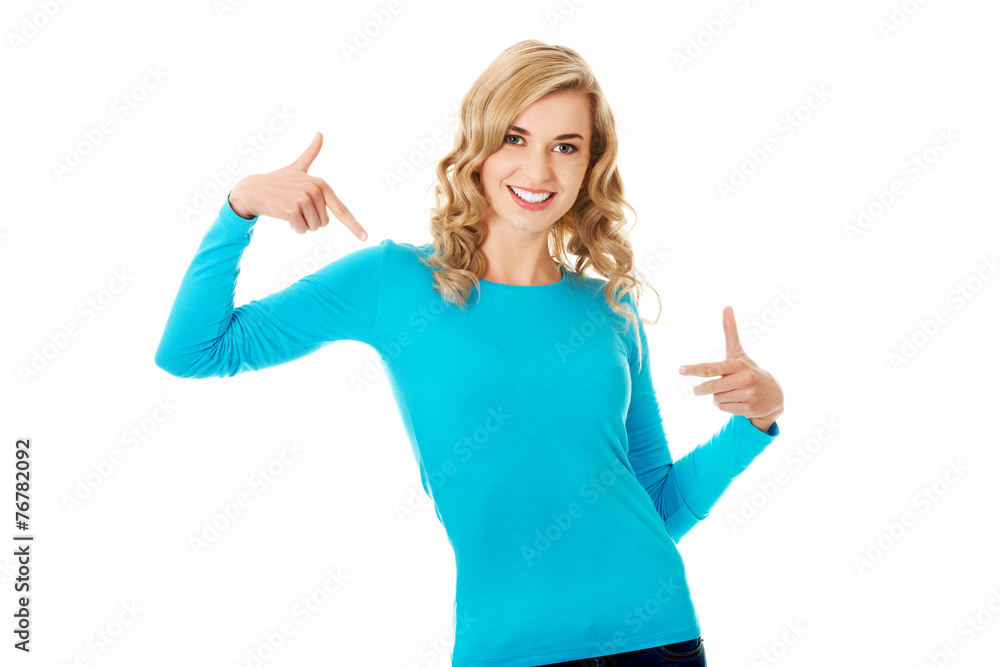 Fototapeta premium Smiling woman pointing at her shirt
