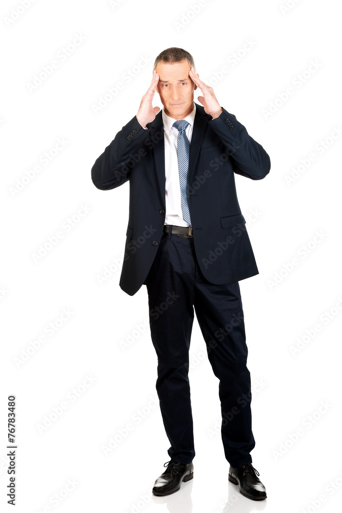 Full length businessman suffering from headache Full length businessman suffering from headache