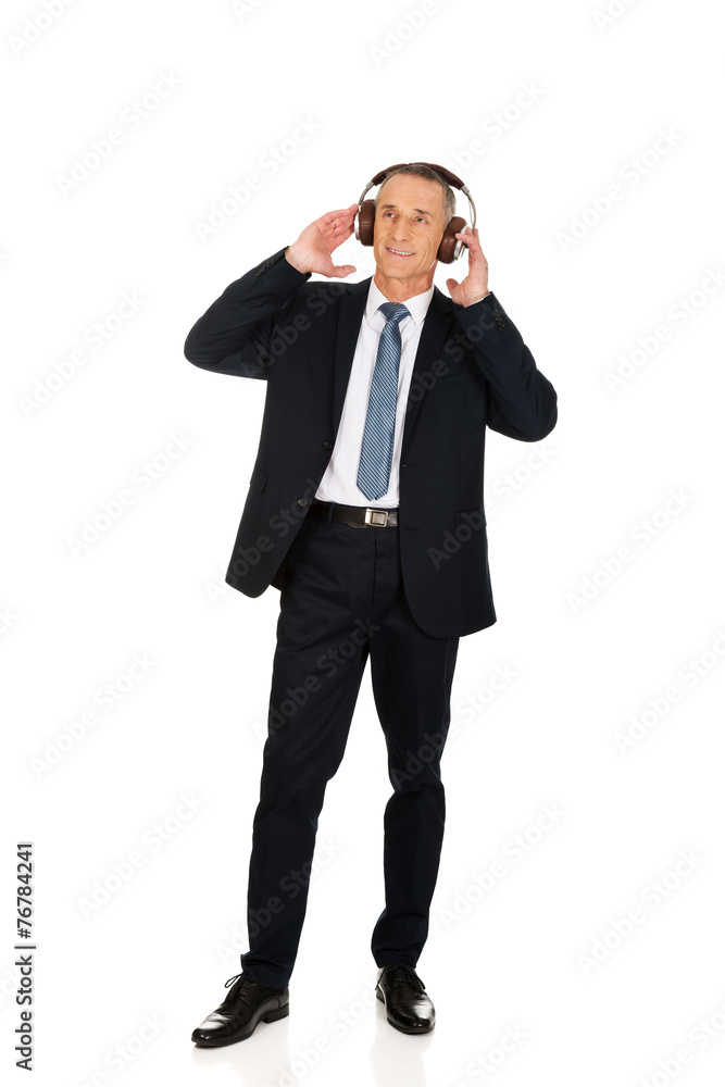 Full length businessman with big headphones Full length businessman with big headphones