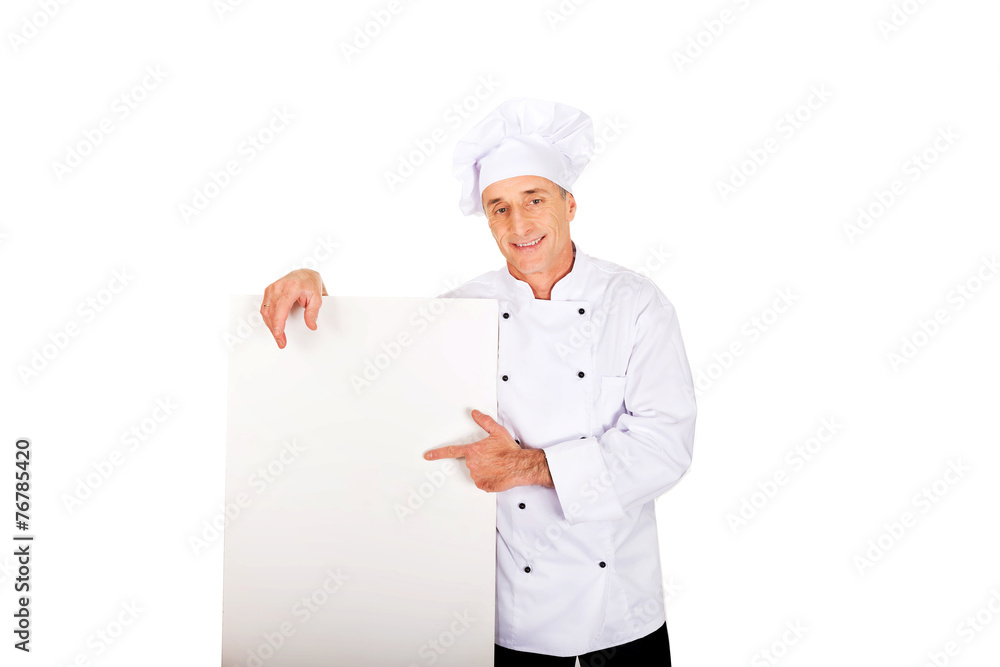 Chef in white uniform holding empty banner Chef in white uniform holding empty banner