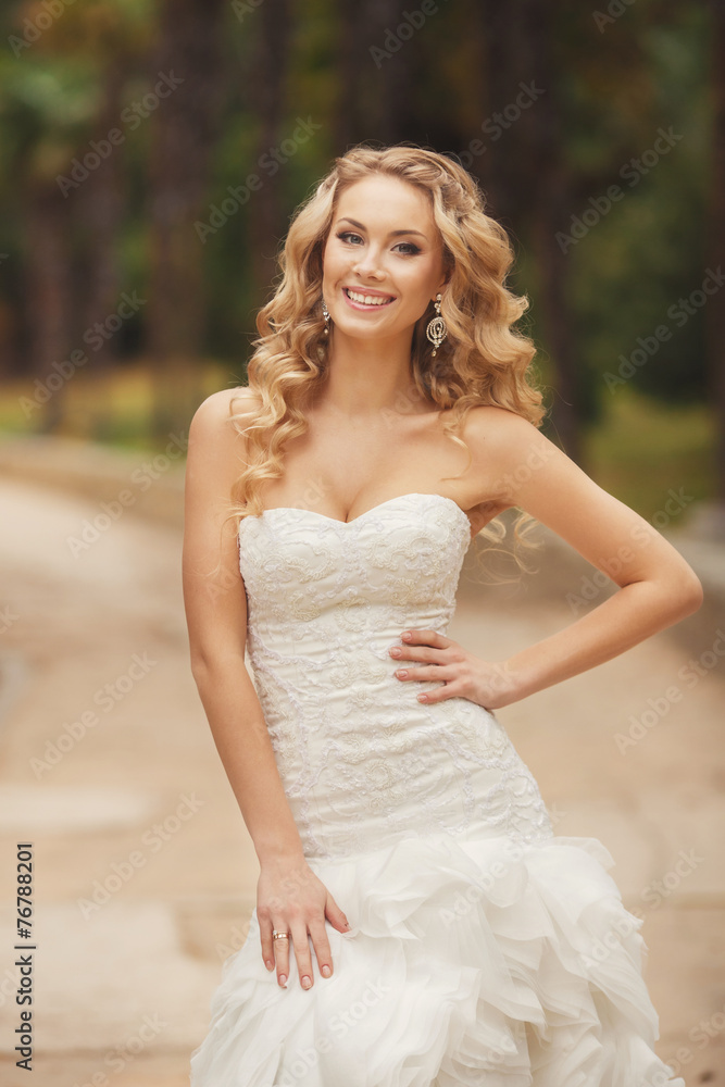 Bride in wedding dress posing in the Park in the summer. Bride in wedding dress posing in the Park in the summer.