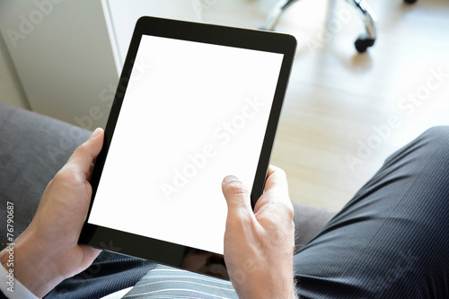 Hands holding tablet pc with empty screen