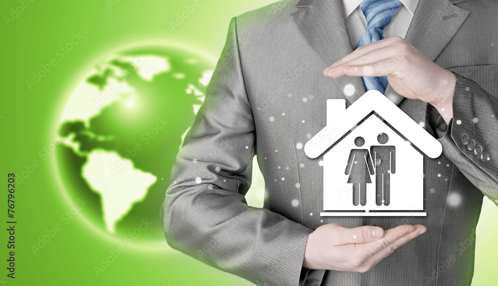 businessman protecting family in home with hands businessman protecting family in home with hands