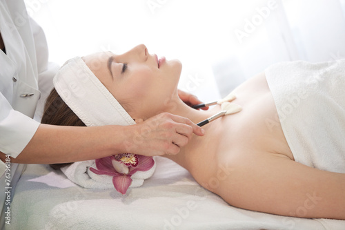 Spa salon  Young Beautiful Woman Having Facial Massage .