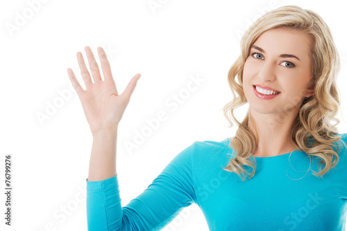 Portrait of a woman waving to the camera