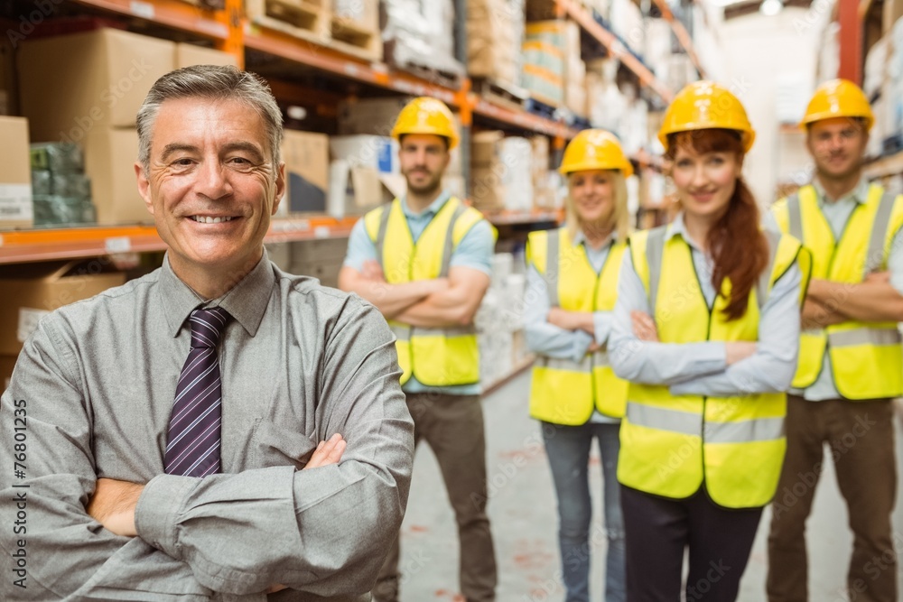 Smiling warehouse team with arms crossed Smiling warehouse team with arms crossed