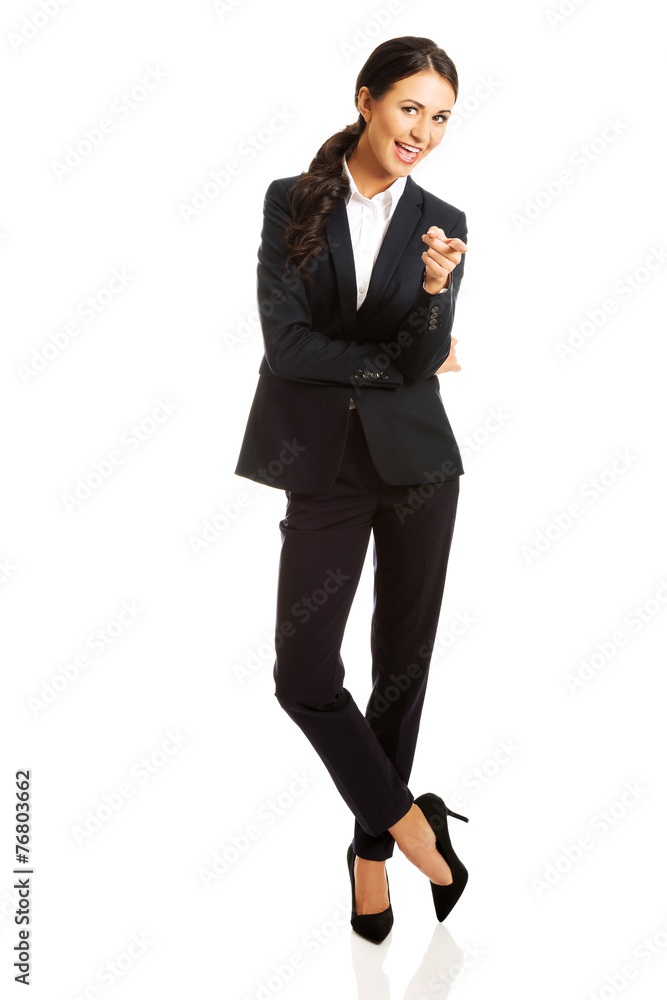 Full length businesswoman pointing at you Full length businesswoman pointing at you