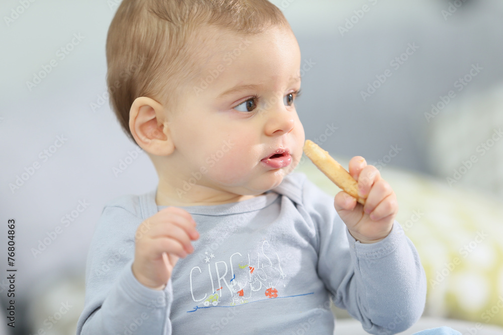 Portrait of cute baby boy eating child biscuit Portrait of cute baby boy eating child biscuit