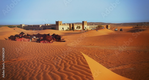 A moroccan desert scenery with sand dunes, desert grass plantati photo