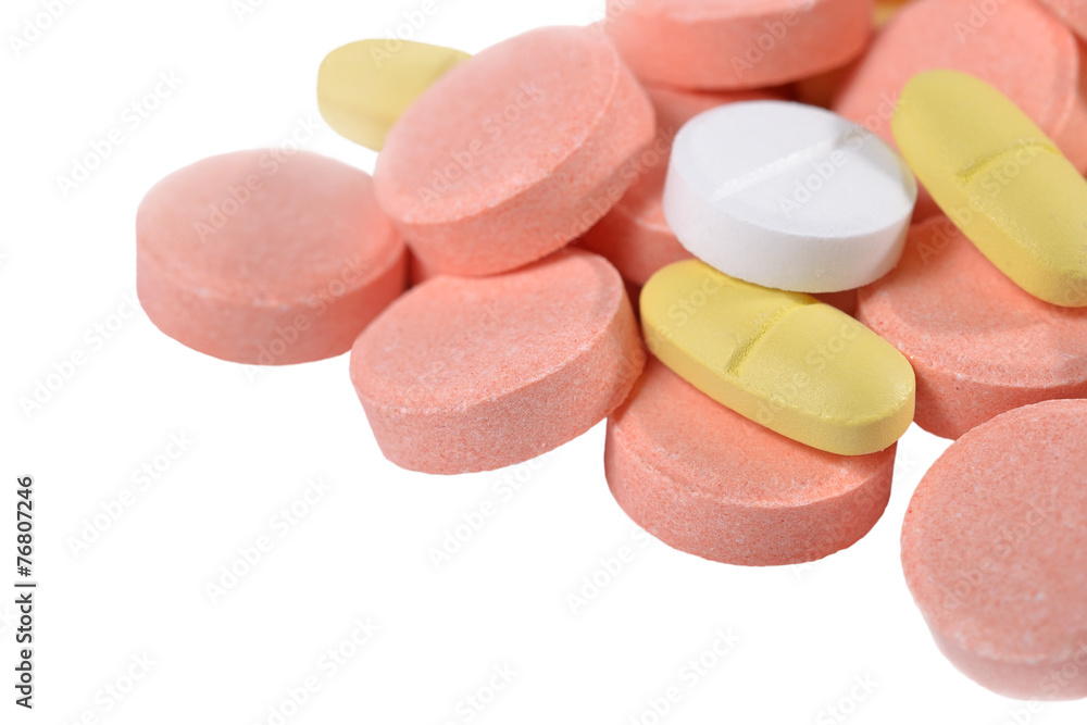 Heap of colorful pills on a white