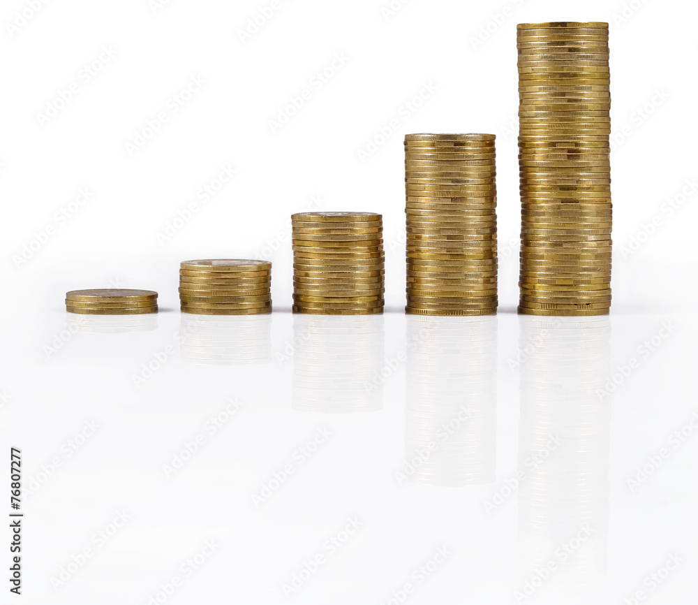 Increasingly higher stacks of gold coins on a white Increasingly higher stacks of gold coins on a white