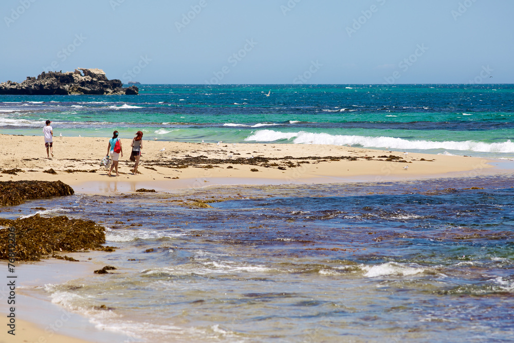 Tourists on tropical beach and ocean