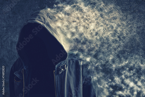 Obraz na płótnie Faceless unrecognizable man vanishing into dust