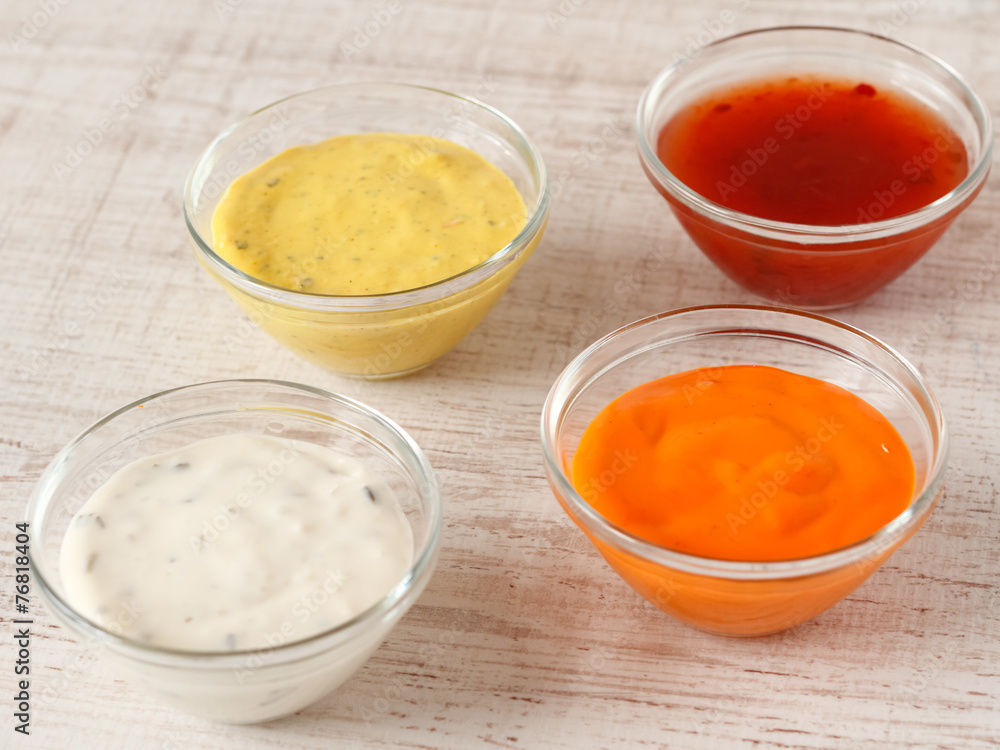 Garlic, chili, curry and cocktail sauce in small bowls Garlic, chili, curry and cocktail sauce in small bowls