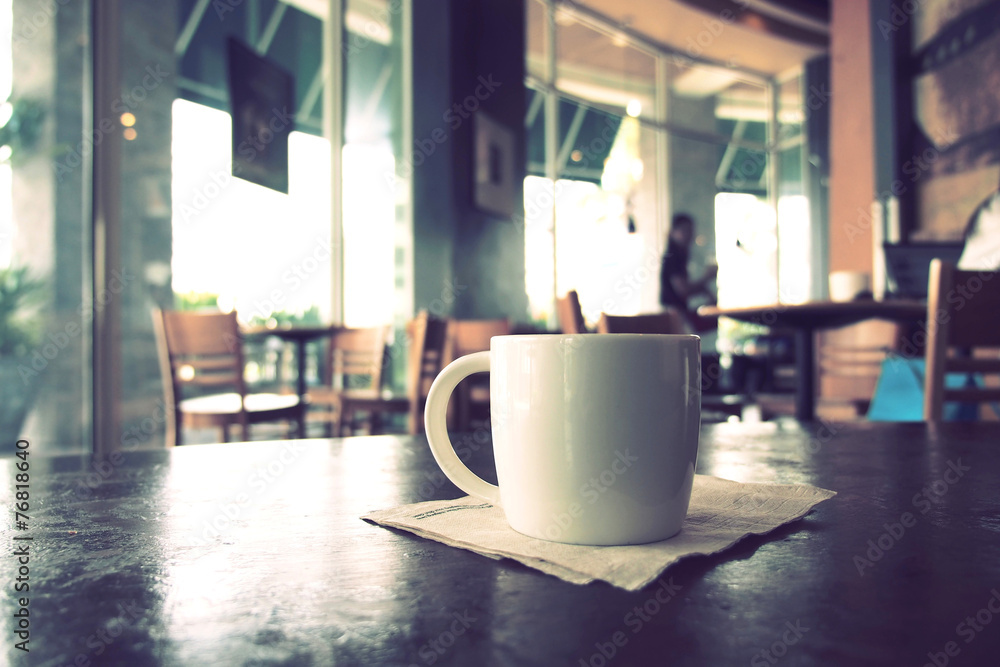 vintage color tone of  cup of coffee  on the table coffee shop