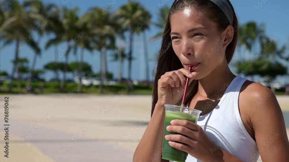 Healthy woman drinking green vegetable smoothie Healthy woman drinking green vegetable smoothie