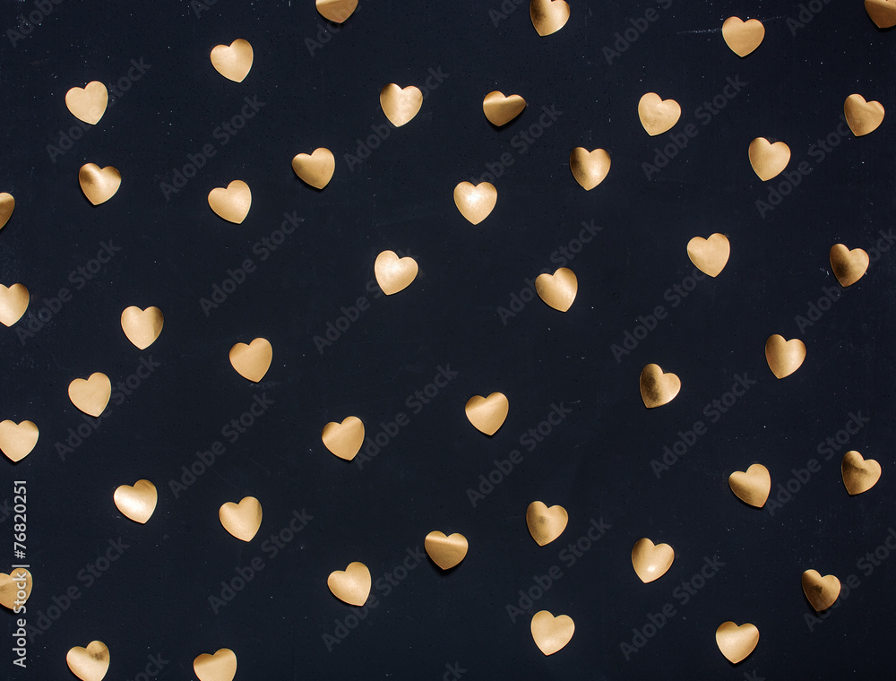 Gold heart stickers on dark textured background