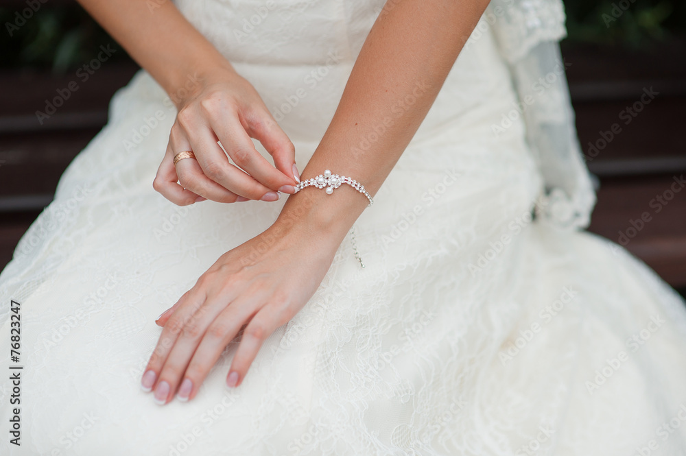hands of a bride with a decoration bracelet hands of a bride with a decoration bracelet