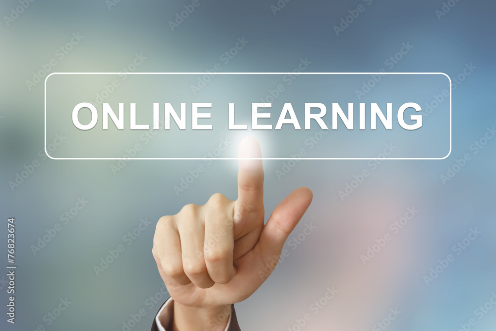 business hand clicking online learning button on blurred backgro business hand clicking online learning button on blurred backgro