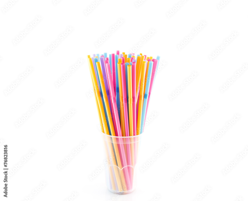 Many straws in plastic glass isolated on white