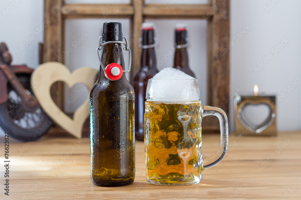Glass tankard of chilled beer with a bottle Glass tankard of chilled beer with a bottle
