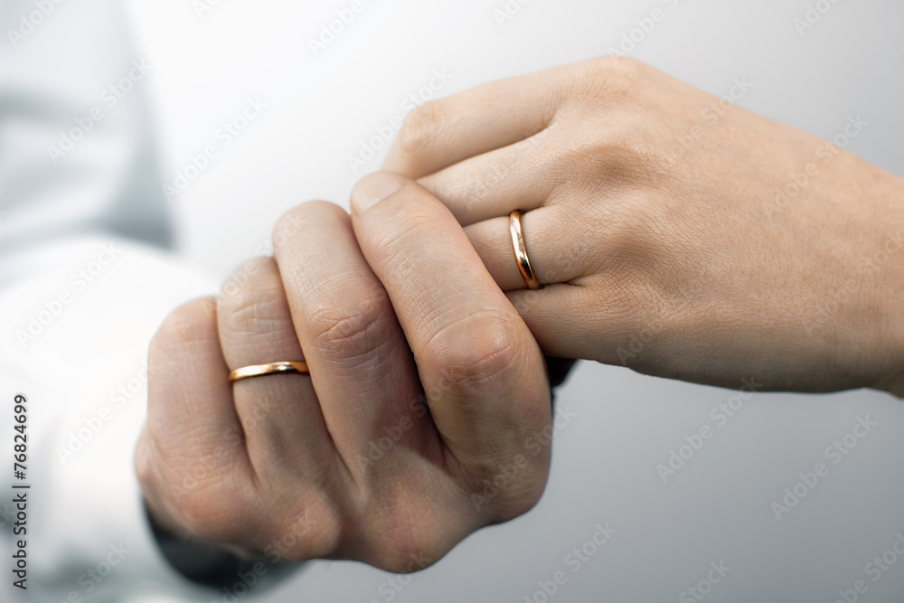 Man's and woman's hands with wedding rings